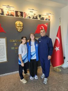 Mira (left) and Maya (centre) in the club's new kit, with Club Coach Ali 