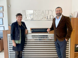 Hasan Bayrak, founder of Voices Newspaper, the voice of expats in Didim for 20 years, and Realty World Didim Office, with After-Sales Support Department Coordinator Laura Bower.